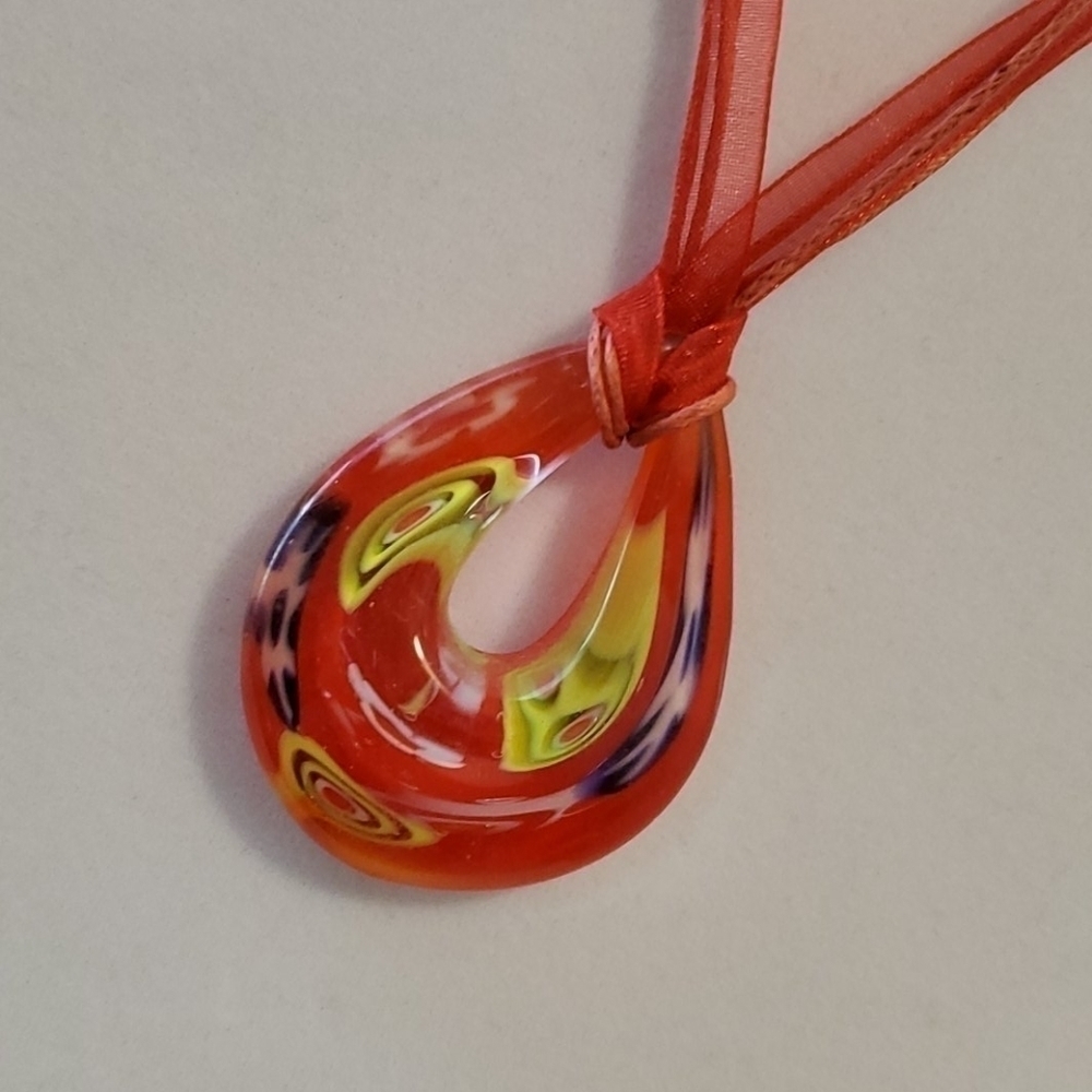 Artsy blown glass on a red ribbon necklace